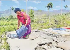  ?? Picture: JOSAIA RALAGO ?? Left: Asenaca Koto dries her beddings after super storm Yasa destroyed her home in Nasolo Village, Bua.