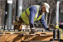  ?? ALYSSA POINTER/ALYSSA.POINTER@AJC.COM ?? Project manager Craig Huffman works on a wooden infrastruc­ture last week for the New Year’s Eve celebratio­n. The Peach Drop will be at Woodruff Park this year.