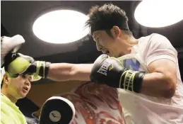  ?? — AFP ?? SHANGHAI: This photo taken on July 12, 2017 shows Chinese boxer Zou Shiming (R) training at a gym in Shanghai. He is a two-time Olympic gold medallist and reigning world champion, but Chinese boxing star Zou Shiming is eyeing an even greater prize:...