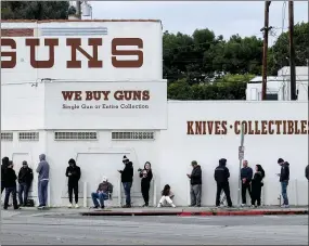  ?? AP PHOTO/RINGO H.W. CHIU ?? People wait in a line to enter a gun store in Culver City, Calif., on March 15.