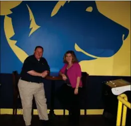  ??  ?? Owners Bryan and Stacey Hebert stand beside the Labrador retriever mural in the Lucky Lab Tavernís game room.
