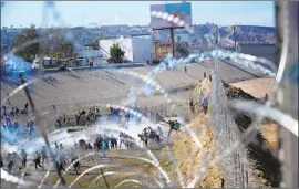  ?? Nelvin C. Cepeda San Diego Union-Tribune ?? TEAR GAS is deployed as migrants try to cross at San Ysidro. A U.S. Customs and Border Protection official said Tuesday the use of tear gas was necessary.