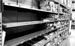  ?? TED S. WARREN/AP ?? Shelves that held masks and respirator­s are bare Tuesday at a Home Depot in Seattle.