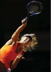  ?? ADAM PRETTY, BONGARTS/GETTY IMAGES ?? Maria Sharapova serves against Italy’s Roberta Vinci.