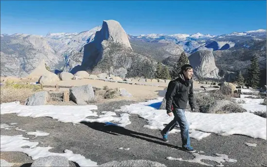  ?? Brian van der Brug Los Angeles Times ?? PATCHY SNOW dots Glacier Point in Yosemite National Park, where Sebastian Richer, 27, hikes. California won’t see much water runoff from the snowpack this year.