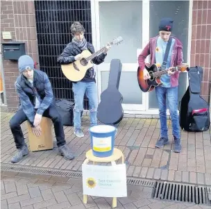  ??  ?? Matthew Bean, Marcus Parr and Matt Ellis busking in Macclesfie­ld to raise money for East Cheshire Hospice