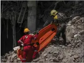  ?? RAMON ESPINOSA — THE ASSOCIATED PRESS ?? Rescuers carry a stretcher on Saturday at the site of Friday's deadly explosion that destroyed the Hotel Saratoga in Havana, Cuba.