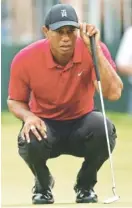  ?? THE ASSOCIATED PRESS ?? Tiger Woods reads the green on the seventh hole Sunday during the final round of the Memorial Tournament in Dublin, Ohio. Woods finished the tournament at 9-under-par 279, tying with five others for 23rd in the standings.
