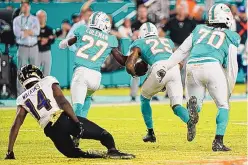  ?? WILFREDO LEE/ASSOCIATED PRESS ?? Miami Dolphins cornerback Xavien Howard (25) runs with the ball for a touchdown after recovering a fumble by Baltimore Ravens wide receiver Sammy Watkins (14) during the second half Thursday night.