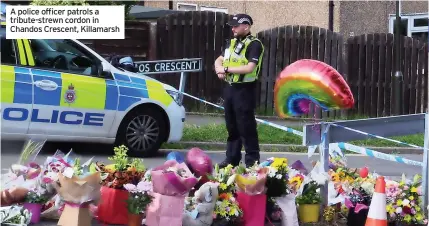  ?? Chandos Crescent, Killamarsh ?? A police officer patrols a tribute-strewn cordon in