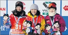  ?? XINHUA ?? Cai Xuetong (center) poses after winning the women’s snowboard halfpipe title at the National Winter Games last Saturday.