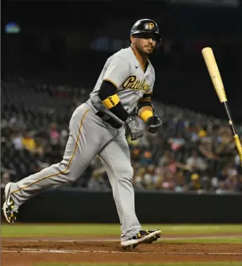  ?? Norm Hall/Getty Images ?? Pirates first baseman Phillip Evans tosses his bat after getting walked Monday in Phoenix, Ariz.