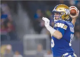 ?? The Canadian Press ?? Winnipeg Blue Bombers quarterbac­k Matt Nichols looks for his receivers during CFL action against the Hamilton Tiger-Cats in Winnipeg on Friday.