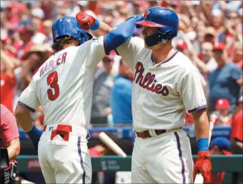  ?? CHRIS SZAGOLA – THE ASSOCIATED PRESS ?? Bryce Harper, left, has a long overdue high-bicep celebratio­n with Rhys Hoskins after Harper’s first-inning home run Sunday against the Atlanta Braves at Citizens Bank Park.