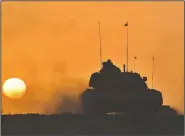  ?? AP/Pool ?? A Turkish army tank moves Friday in Silopi near the Habur border gate with Iraq, southeaste­rn Turkey. Tanks with Turkish and Iraqi soldiers holding the Turkish and Iraqi flags rolled on a field as the two countries’ militaries conducted joint exercises...