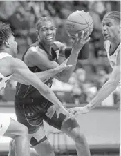  ?? MATT GENTRY/AP ?? Miami’s Kameron McGusty drives between Virginia Tech’s Darius Maddox and David N’Guessan during their game Wednesday.