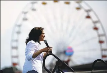 ?? John Locher Associated Press ?? KAMALA HARRIS said Saturday that President Trump “didn’t pull the trigger, but he’s tweeting out the ammunition.” She and several rivals joined in Elizabeth Warren’s call for Walmart to stop selling guns.