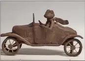  ?? ?? The wind whips this toad’s scarf as he drives his 1923 Ford Model T. The 5-by-9-inch bronze statue will go to the former Smith Ford building on Front Street.