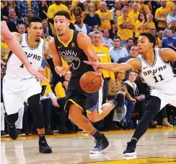  ?? (Reuters) ?? GOLDEN STATE WARRIORS guard Klay Thompson (with ball) scored 31 points in the Warriors’ 116-101 home victory over the San Antonio Spurs on Monday night to take a 2-0 lead in the Western Conference first-round playoff series.