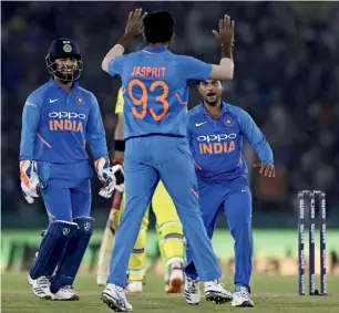  ?? AP ?? Indian players celebrate the dismissal of Australia’s Glenn Maxwell. But Australia chased down 359 to stun India in the fourth one-day game in Mohali. —