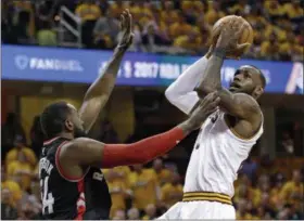  ?? TONY DEJAK — ASSOCIATED PRESS ?? LeBron James drives against the Raptors’ Patrick Patterson during the first half May 1.