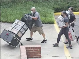  ?? Gerry Broome Associated Press ?? NORTH CAROLINA State University in Raleigh staggered students’ return over 10 days to prevent the usual mobs of students and parents on campus all at once.