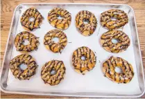  ?? ROBERTO E. ROSALES\JOURNAL ?? A tray of chocolate turtle doughnuts at Doughboy’s Bake Shoppe.