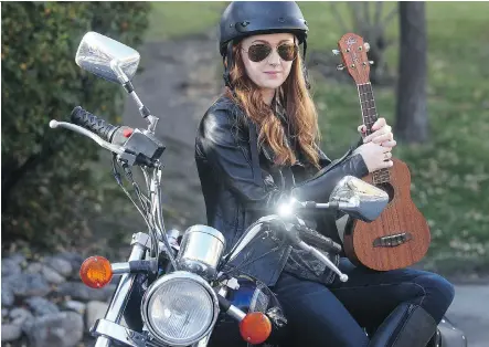  ?? TED RHODES/ CALGARY HERALD ?? Motorcycle riding, ukulele strumming Allison Lynch plays Juliet — who Lynch calls the “ultimate badass” — in the Shakespear­e Company production of Romeo and Juliet which runs through Oct. 17. Lynch is pictured with her ride in Lower Mount Royal.