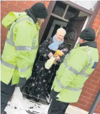  ??  ?? ●●PCSOs in Rochdale delivering milk to an elderly resident who was unable to get out because of the snow.