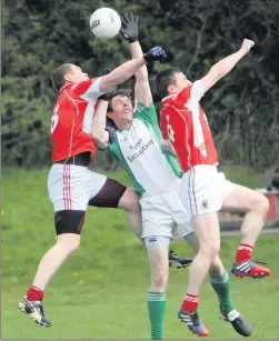  ??  ?? Tinahely’s David Dillon and Conor Hatton jump with Donard’s Brian Lennon during the SFL Division 1A clash in Tinahely. Photo: Joe Byrne.