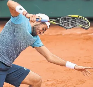  ?? ERIC FEFERBERG/AFP/GETTY IMAGES ?? Italy’s Matteo Berrettini smashes his racquet into the court after a point against Austria’s Dominic Thiem during their men’s singles match in Paris on Friday.