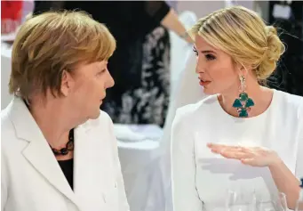  ??  ?? Dinner diplomacy: Miss Trump chats to German chancellor Angela Merkel