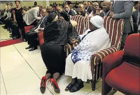  ??  ?? Ayanda is comforted by first lady Tobeka Madiba-Zuma at the memorial service for the late gospel star.