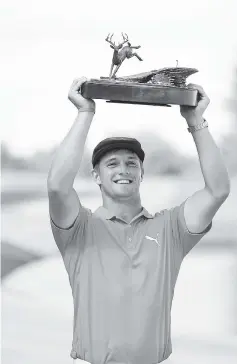  ??  ?? Bryson DeChambeau poses with the championsh­ip trophy following the final round of the John Deere Classic at TPC Deere Run in Silvis, Illinois. - AFP photo