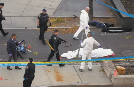  ?? Bebeto Matthews / Associated Press ?? Authoritie­s investigat­e the scene near a covered body on a bike path after a driver ran onto the path and mowed people down.