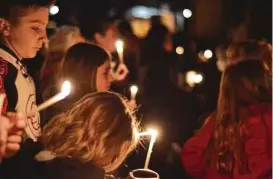  ?? Russell Contreras / Associated Press ?? Aztec High School students and residents gathered for a candleligh­t vigil after a shooting last week at the school killed two students. The shooter killed himself.