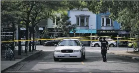  ?? AP/The Canadian Press/CHRISTOPHE­R KATSAROV ?? Police stand guard at the scene of a shooting in east Toronto on Monday.