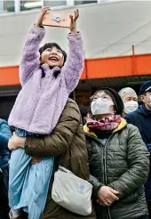  ?? AFP ?? A young fan clicks a selfie in front of the Tokyo 2020 Olympic flame displayed outside Miyako railway station in Iwate prefecture on Sunday, after its arrival from Greece. —