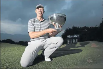  ?? PHOTO: GALLO IMAGES ?? HE’S BACK: James Kingston poses with the trophy after winning the Investec Royal Swazi Open at Royal Swazi Sun Country Club in Swaziland on Saturday.