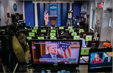  ?? (The New York Times/Pete Marovich) ?? President Donald Trump’s taped farewell address appears on a FOX News TV monitor in the White House briefing room as it is broadcast Tuesday.