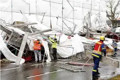  ??  ?? Federal Agency for Technical Relief workers dismantle scaffoldin­g overturned by the storm in Berlin. — Reuters photo