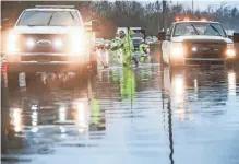  ?? MATT STONE/LOUISVILLE COURIER JOURNAL ?? Crews work to clear water from Interstate 264 on Friday in Louisville, Ky. Mayor Craig Greenberg issued a state of emergency Friday evening because of the severe storms, high winds and widespread damage.