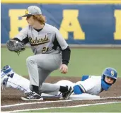  ?? JAMES C. SVEHLA/DAILY SOUTHTOWN ?? Richards’ Neil Glynn covers first base as Sandburg’s Jason Sullivan slides back safely during a nonconfere­nce game in Orland Park on March 24.