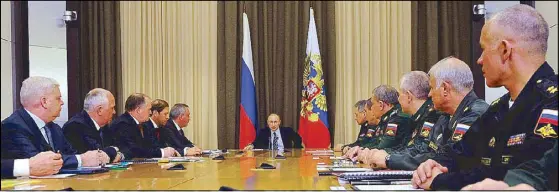  ?? AP ?? Russian President Vladimir Putin, center, meets with military officials in Sochi, as he vowed to counter US military moves and maintain a strategic parity.