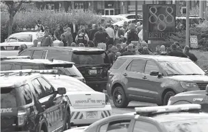  ??  ?? Police secure the scene of a shooting Thursday at the Capital Gazette newspaper office in Annapolis, Md. Five people were killed and two others were wounded.