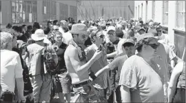  ?? Stephen Brashear European Pressphoto Agency ?? A CROWD WAITS outside Cannabis City in Seattle to purchase recreation­al marijuana on the first day of legal sales. Sales have only increased since.