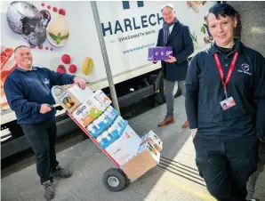  ?? PATRICK OLNER ?? Feed Newport food bank manager Gemma Walker, right, takes a delivery from Harlech Foodservic­e driver Tony Thomas, left, and managing director David Cattrall