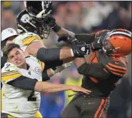  ?? (AP file photo) ?? Cleveland Browns defensive end Myles Garrett swings a helmet at Pittsburgh Steelers quarterbac­k Mason Rudolph as offensive lineman David DeCastro intervenes during a game last year. Garrett said he and the Browns are past the incident, for which he served a six-game suspension, and hopes the Steelers are as well as the teams prepare to face off Sunday in Pittsburgh.