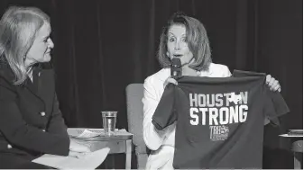  ?? Mark Mulligan / Staff photograph­er ?? House Democratic leader Nancy Pelosi, who has family in the area, displays a Houston Strong shirt while campaignin­g with congressio­nal candidate Sylvia Garcia on Wednesday at Talento Bilingüe.