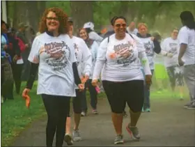  ?? MICHILEA PATTERSON — DIGITAL FIRST MEDIA ?? People walk on the Schuylkill River Trail at Riverfront Park in Pottstown after getting covered in colored powder for the local YWCA Race Again Racism 5K on Saturday.